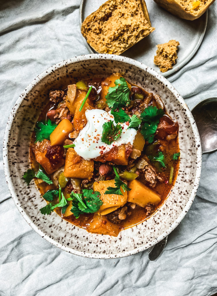 Pumpkin chili in a bowl with dollop of sour cream on top